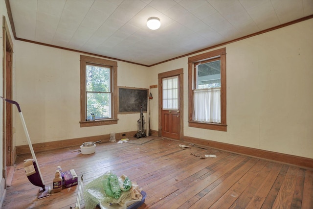 unfurnished room featuring hardwood / wood-style floors and crown molding