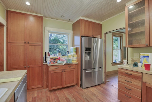 kitchen with stainless steel fridge with ice dispenser, light hardwood / wood-style flooring, and ornamental molding