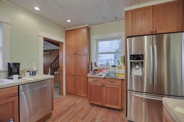 kitchen featuring sink, ornamental molding, light hardwood / wood-style floors, wood ceiling, and stainless steel appliances