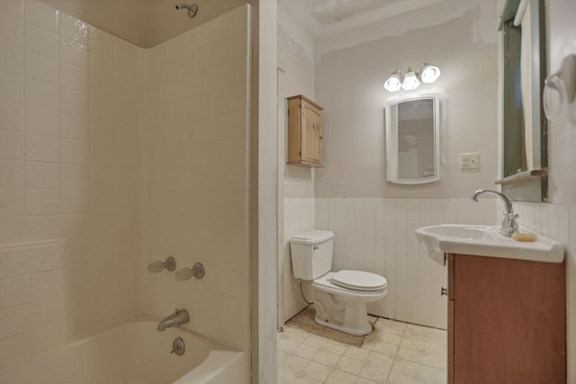 full bathroom with vanity, tiled shower / bath combo, and toilet