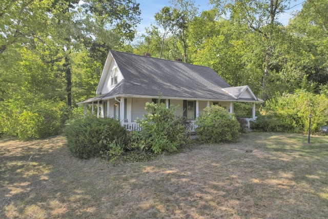 view of side of property with a porch