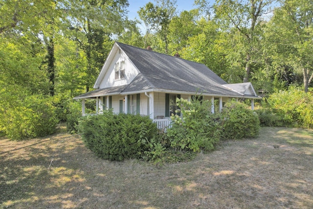 view of side of property featuring a porch