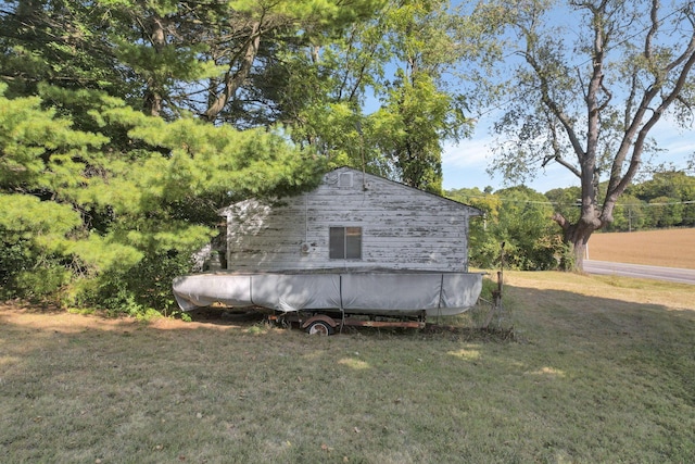 view of outdoor structure featuring a yard and a swimming pool