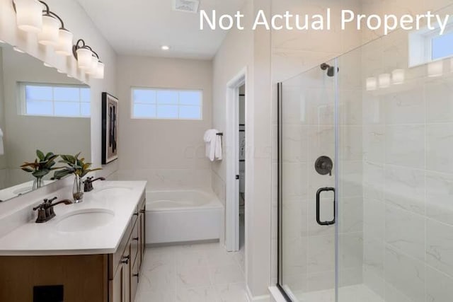 full bathroom featuring marble finish floor, visible vents, a sink, and a stall shower