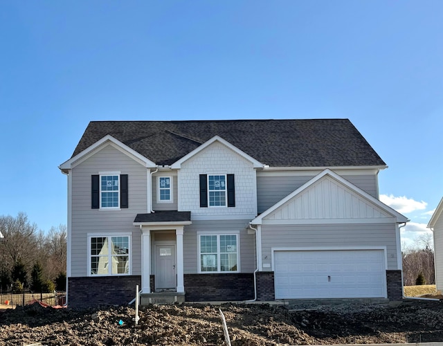 view of front of house featuring a garage, brick siding, and roof with shingles