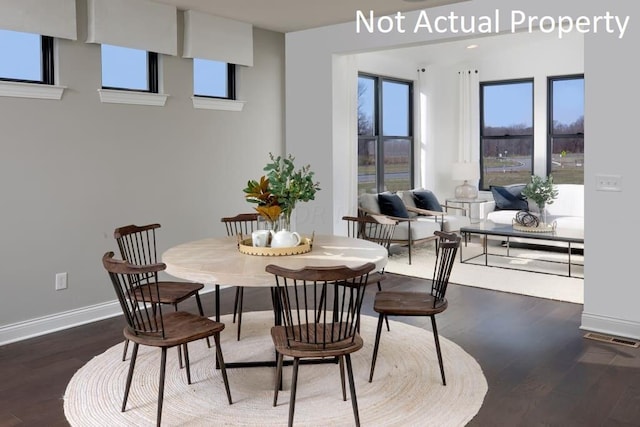 dining space with visible vents, baseboards, and wood finished floors