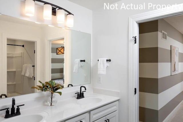 full bath featuring double vanity, visible vents, and a sink