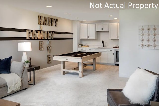 playroom with light carpet, a sink, baseboards, recessed lighting, and indoor wet bar
