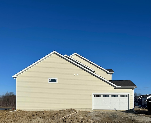 view of side of home with a garage