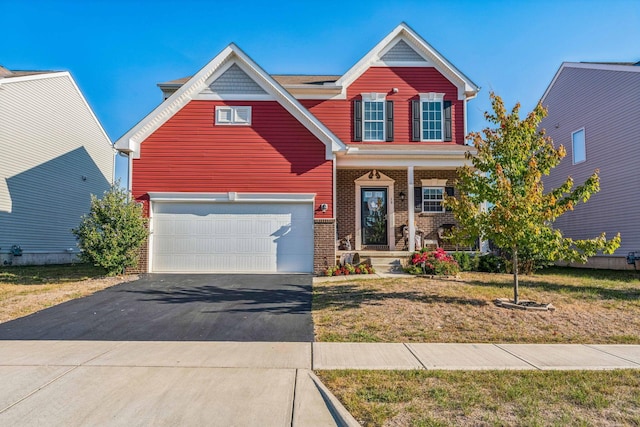 view of front of home with a front yard and a garage