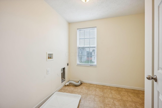 laundry room with hookup for a washing machine, a textured ceiling, and hookup for an electric dryer