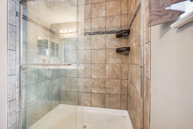 bathroom with a shower with shower door