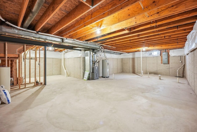 basement featuring electric panel and electric water heater