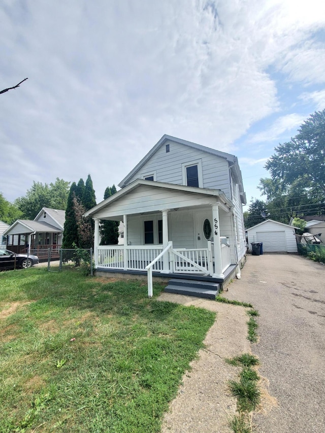 view of front of house featuring a garage, an outdoor structure, and a front yard