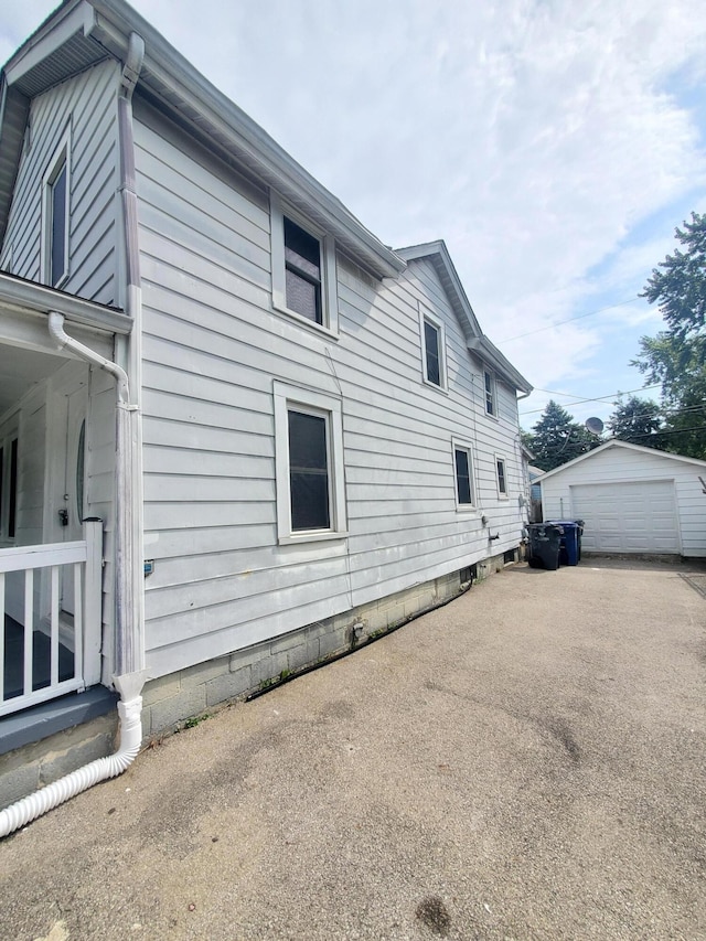 view of home's exterior featuring an outbuilding and a garage