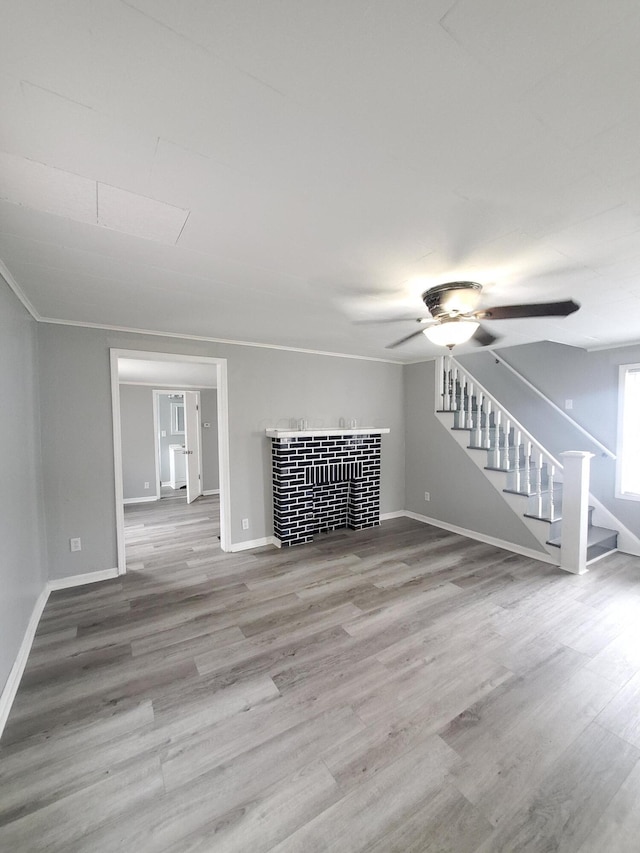 unfurnished living room featuring ceiling fan, crown molding, and hardwood / wood-style flooring