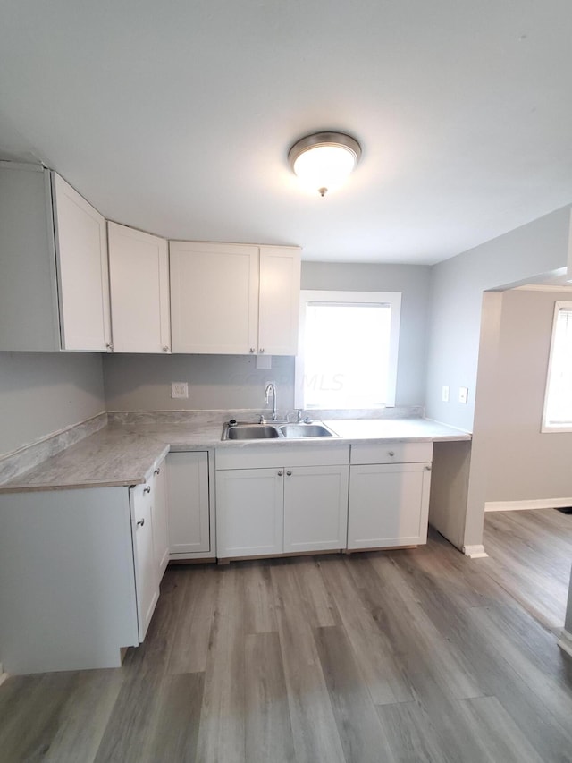 kitchen featuring white cabinetry, plenty of natural light, and sink