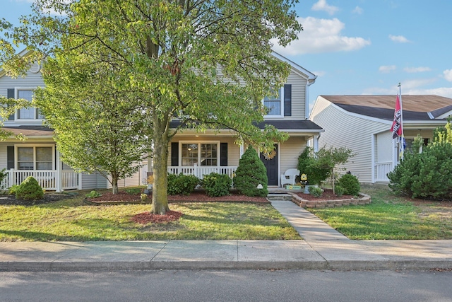 view of front of house with covered porch and a front lawn