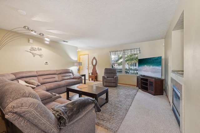 carpeted living room featuring a textured ceiling