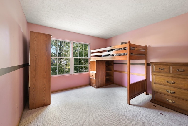 unfurnished bedroom with light carpet and a textured ceiling