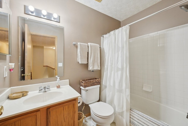 full bathroom with vanity, shower / tub combo, a textured ceiling, and toilet