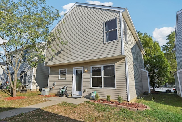 view of front of house featuring central AC and a front lawn