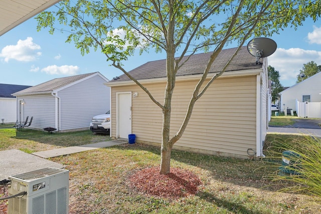 view of side of home with a lawn