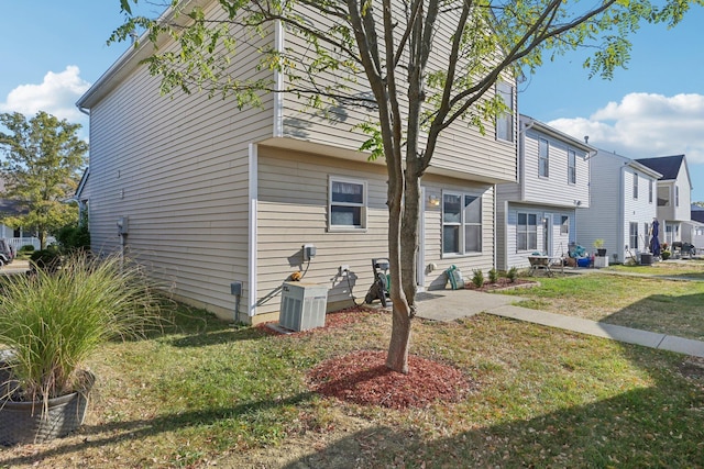 view of home's exterior with a lawn and cooling unit