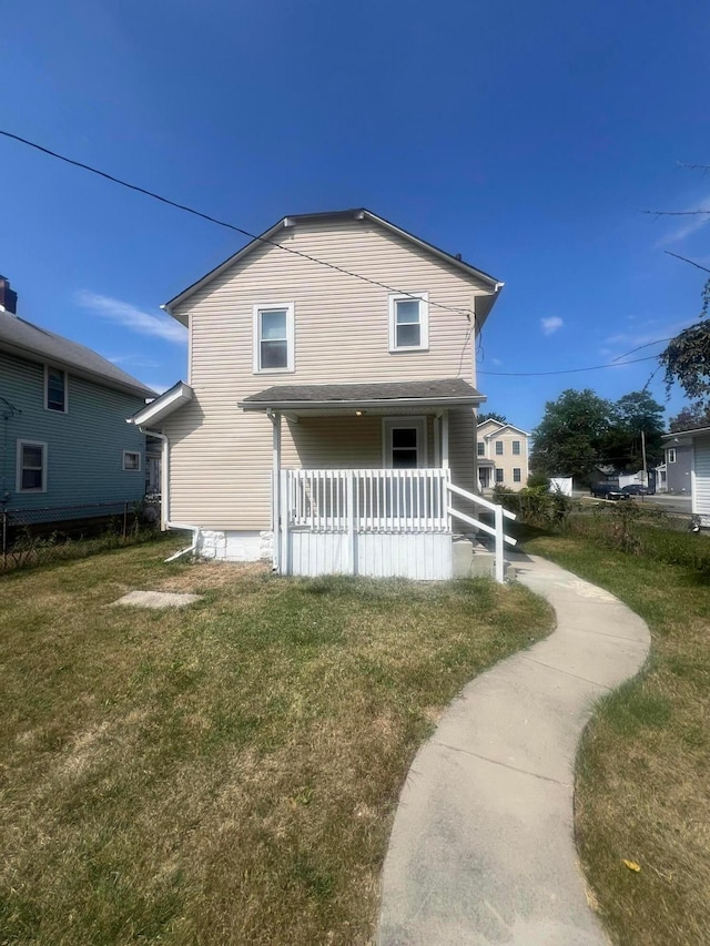 rear view of property with a yard