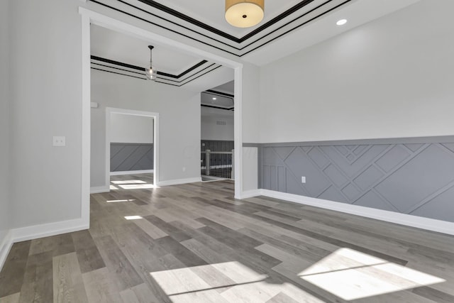 13917 Fantasy Way, Pickerington, OH 43147 - empty room featuring hardwood / wood-style flooring, a raised ceiling, and an inviting chandelier