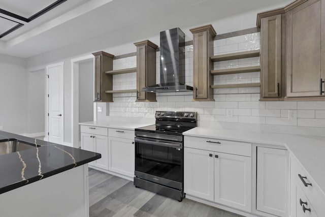 13917 Fantasy Way, Pickerington, OH 43147 - kitchen with tasteful backsplash, wall chimney range hood, light hardwood / wood-style flooring, white cabinets, and black range with electric stovetop