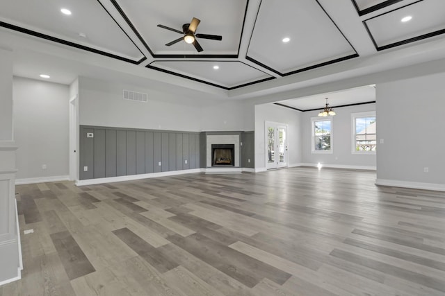 13917 Fantasy Way, Pickerington, OH 43147 - unfurnished living room with ceiling fan with notable chandelier, light wood-type flooring, and coffered ceiling