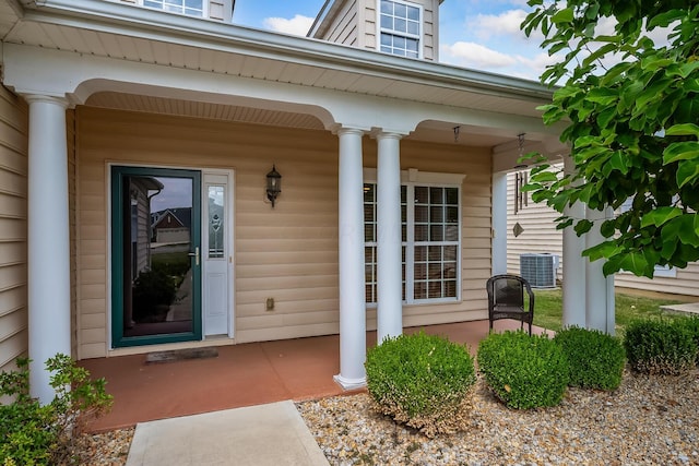 doorway to property featuring covered porch and central AC