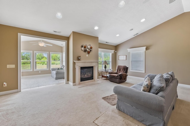 carpeted living room featuring plenty of natural light, ceiling fan, and lofted ceiling