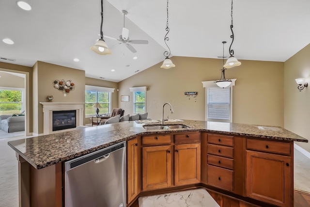 kitchen with vaulted ceiling, stainless steel dishwasher, a wealth of natural light, and sink