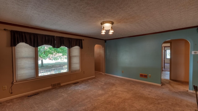 carpeted empty room featuring a textured ceiling and ornamental molding