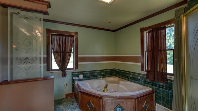 bathroom featuring crown molding, plenty of natural light, and a bathtub