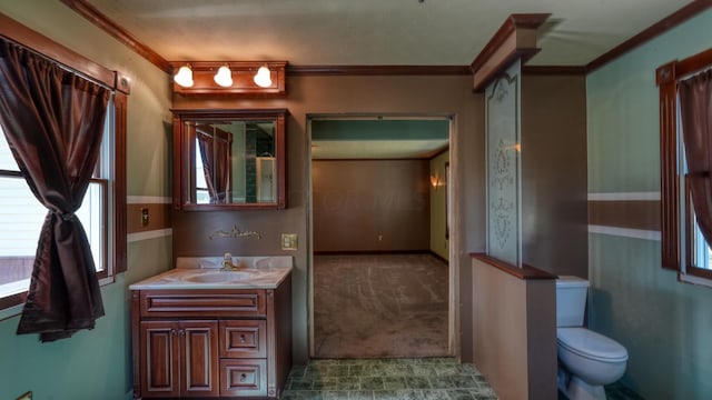 bathroom featuring vanity, toilet, and crown molding