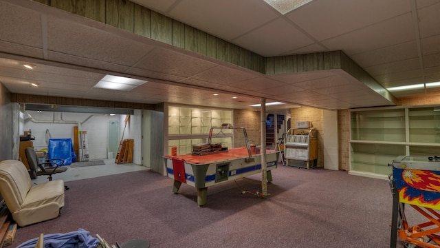 rec room featuring carpet and a drop ceiling