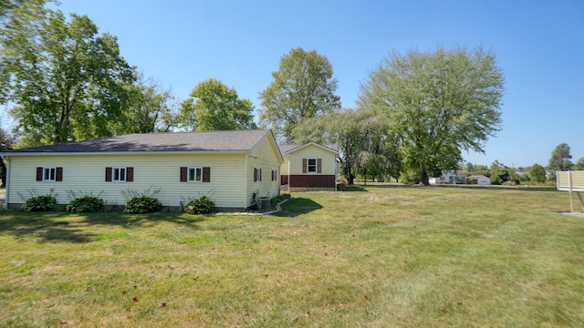 view of home's exterior with central AC and a lawn