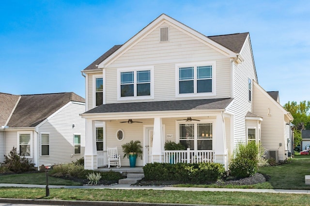 view of front of home with ceiling fan, a front lawn, and covered porch