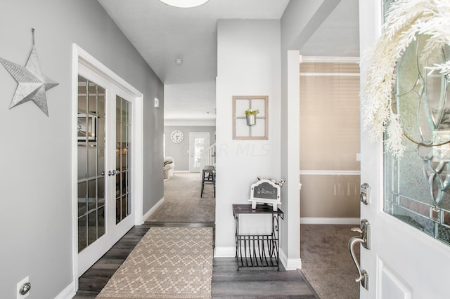 foyer entrance with dark wood-type flooring and french doors