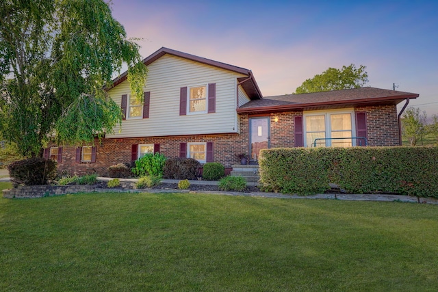 split level home featuring a yard