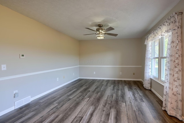 spare room featuring ceiling fan, dark hardwood / wood-style flooring, and a textured ceiling