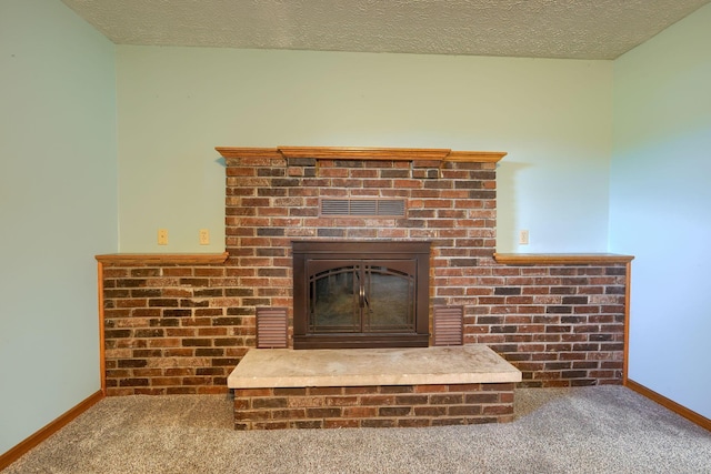 interior details with carpet, a textured ceiling, and a brick fireplace