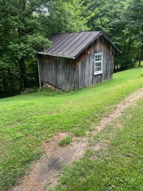 view of outbuilding with a yard