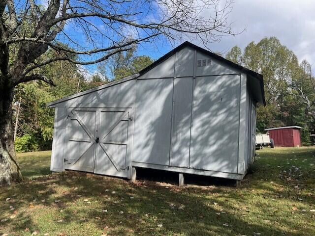 view of outdoor structure with a lawn