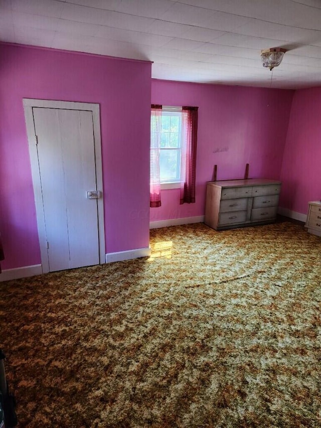 unfurnished bedroom with carpet flooring and a closet