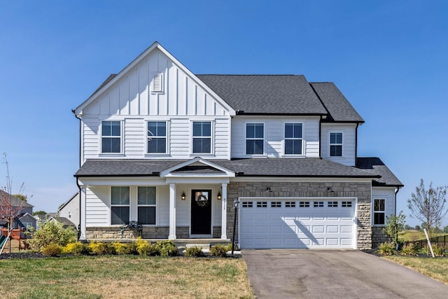 view of front of home featuring a front yard and a garage