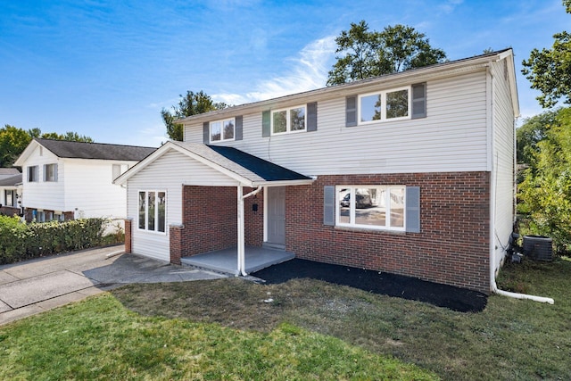 front of property featuring central AC unit and a front lawn